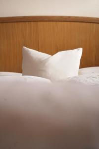 a white pillow sitting on top of a bed at Apartment Pössnecker in Selva di Val Gardena