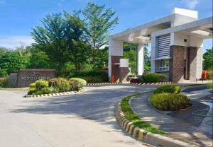 a large white building with a sign in front of it at Family-Friendly Condo Units at Matina Enclaves in Davao City