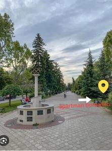 a monument in the middle of a road with trees at Apartman Borsalino Subotica in Subotica
