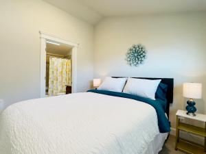 a bedroom with a large white bed and a window at The Queen of Eastlake in Seattle