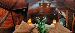 a bedroom in a tree house with a bed and pillows at Starlit Dome Mcleodganj in Dharamshala +26 photos