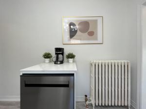 a kitchen with a coffee maker and a radiator at 2B with parking, 10km to Toronto downtown in Toronto