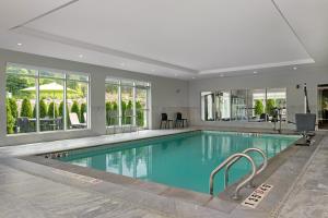 a large swimming pool in a house with a swimming poolvisorvisor at Home2 Suites By Hilton Huntsville in Huntsville