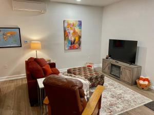 a living room with a flat screen tv and a couch at Foxs Den Hot Tub Bbq Queen Bed Sleeps 2 in Ahwahnee