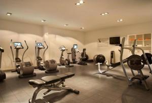 a gym with several cardio machines in a room at Tortuga beach lovely 2 bed apartment and gardens in Santa Maria