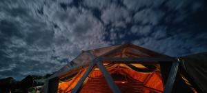 a tent under a cloudy sky at night at Starlit Dome Mcleodganj in Dharamshala +27 photos