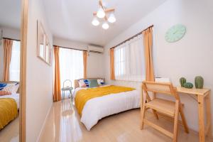 a bedroom with a bed and a desk and a clock at HOTEL Flag Tokyo - Vacation STAY 29759v in Tokyo