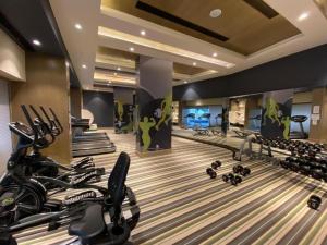 a gym with a bowling alley with exercise equipment at Golden Penthouse - Couple Friendly - DLF My pad, Gomtinagar, Lucknow in Lucknow
