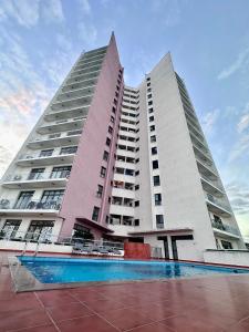 two tall buildings with a pool in front of them at The Perfect Cozy Home For You in Dar es Salaam