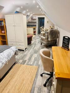 a bedroom with a bed and a table and chairs at The Honeysuckle Coop in Grantham