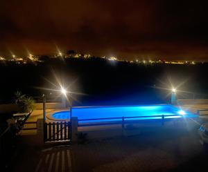 a swimming pool at night with lights at Terra Luso Proche De Montejunto in Cadaval