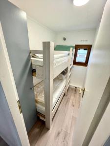 a small room with bunk beds in it at FeWo-Krone in Heringsdorf +8 photos