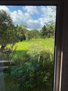 a view of a field from a window at Domki że Hej Bieszczady in Ustrzyki Dolne