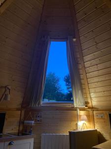 a room with a window in a wooden house at Cabane, Kota Désiré in Saint Die