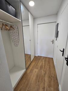 a walk in closet with a mirror and a door at Studio Le Santa-Maria - Frejus Plage in Fréjus