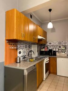 a kitchen with wooden cabinets and a counter top at REAL VIP Hostel in Krakow