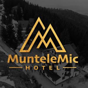 a sign for a mountainine hotel on a building at Hotel Muntele Mic in Borlova