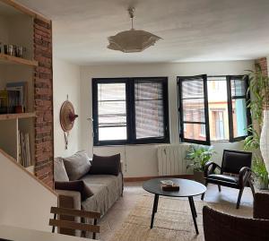 een woonkamer met een bank en een tafel bij A 150 pas du Capitole! in Toulouse