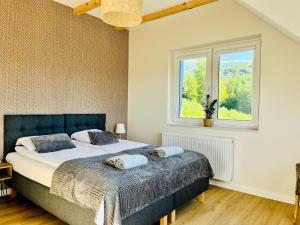 a bedroom with a bed and a window at Bukowe Tarasy in Wetlina +96 photos