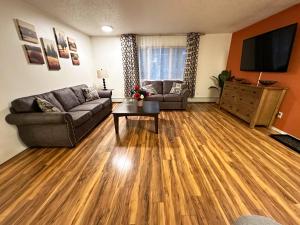 a living room with a couch and a table at Stay Anchorage! Furnished Two Bedroom Apartments With High Speed WiFi in Anchorage