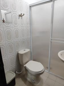 a bathroom with a toilet and a shower and a sink at Mami Yola in Valledupar