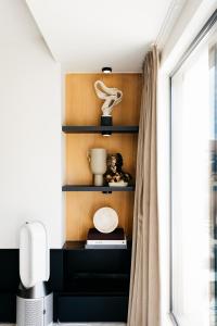 a room with a shelf with a window at The Edgewater Suites - RIVERSIDE in Namur