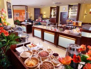 a buffet line with bowls of food in a restaurant at Hotel Landsknecht in Uckerath