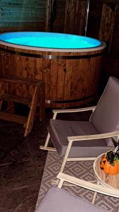 a chair and a tub with a pumpkin in front of it at Sèid Bò - Sleeps 6 - NEW Private 6 Person HotTub Available in Burnfoot