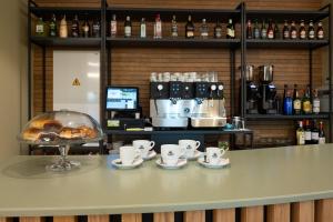 a counter with cups and saucers and a bakery at Hotel Aldama in Mérida