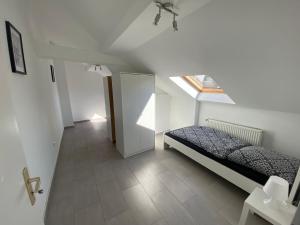 a bedroom with a bed and a window in a attic at Ferien-& Monteurwohnung Zentral 2 in Übach-Palenberg