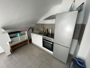a kitchen with a white refrigerator and a sink at Ferien-& Monteurwohnung Zentral 2 in Übach-Palenberg