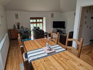 a living room with a wooden table and a dining room at The Granary House - Luxury Stays in Plymouth