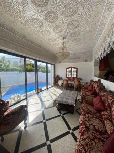 un soggiorno con soffitto a cassettoni e divano di Villa Hanaa a Mohammedia