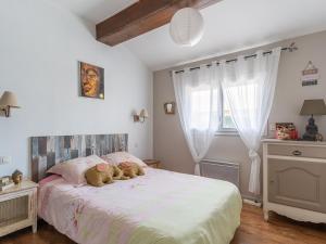 a bedroom with a bed with two teddy bears on it at Maison à Mimizan avec piscine, 4 personnes, proche lac, activités à proximité - FR-1-50-102 in Mimizan
