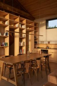 a large wooden table and chairs in a kitchen at La Ferme de Brouage - GIte #3 in La-Gripperie-Saint-Symphorien