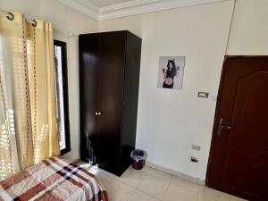 a bedroom with a bed and a picture on the wall at DeadSea Accommodation with AC in Sowayma