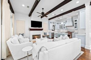 a living room with white furniture and a fireplace at Our Happy Place in Santa Rosa Beach