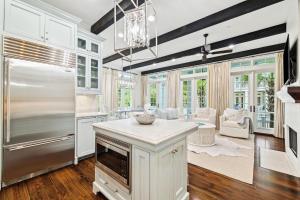 a kitchen with a refrigerator and a table in it at Our Happy Place in Santa Rosa Beach