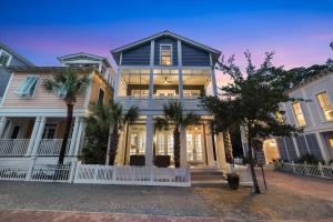 a large house with palm trees in front of it at Our Happy Place in Santa Rosa Beach