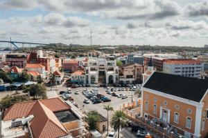 a city with cars parked in a parking lot at Elements Hotel & Shops Curaçao in Willemstad