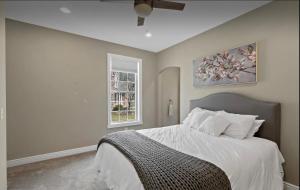 a bedroom with a large bed and a window at Custom Home & Located 20min to Downtown Saratoga Springs - Belmont Stakes in Schenectady