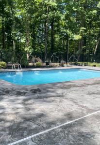 a large blue swimming pool in a parking lot at Custom Home & Located 20min to Downtown Saratoga Springs - Belmont Stakes in Schenectady