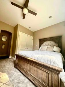 a bedroom with a large bed with a ceiling fan at Custom Home & Located 20min to Downtown Saratoga Springs - Belmont Stakes in Schenectady
