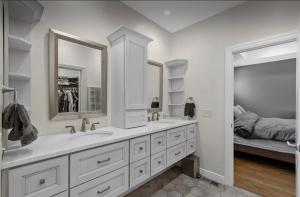 a bathroom with two sinks and a large mirror at Custom Home & Located 20min to Downtown Saratoga Springs - Belmont Stakes in Schenectady