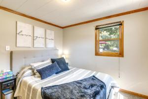 Un dormitorio con una cama con almohadas azules y una ventana en Green Bay Vacation Rental - Walk to Lambeau Field en Green Bay