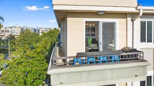 a balcony with blue chairs on a house at Beverly Hills Penthouse 2 BR Apt with Parking 407 in Los Angeles