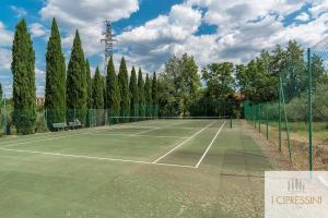 a tennis court with trees and a fence at Villa Le Tortore privata lusso piscina relax Siena in Siena