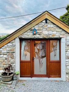 a small stone cottage with a wooden door at Four à pain in Sprimont