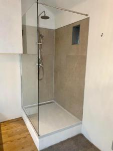 a shower with a glass door in a bathroom at Four à pain in Sprimont