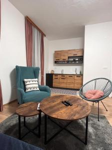 a living room with a table and a chair at Apartments Ejla&Una in Mostar